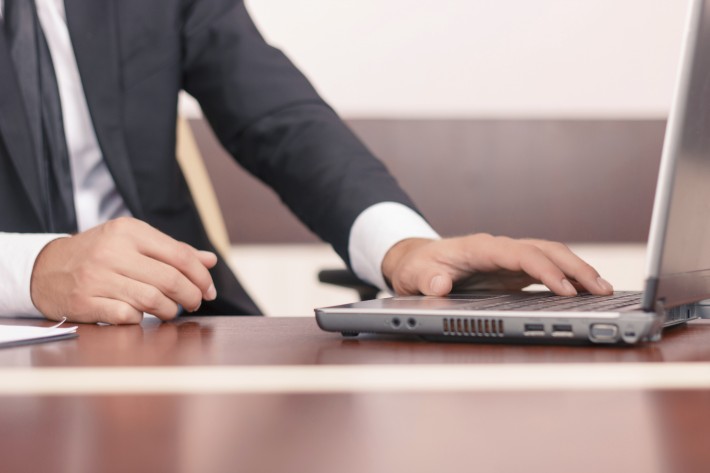 Handsome lawyer working on his laptop